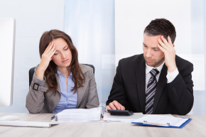 Woman and Man Working with Calculator