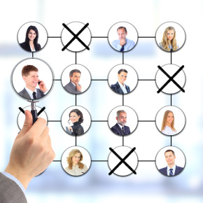 Businessman cutting back jobs. All on white background.