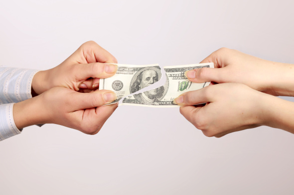 Hands tear money isolated on white background