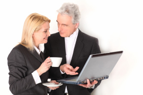 Man showing woman something on laptop computer