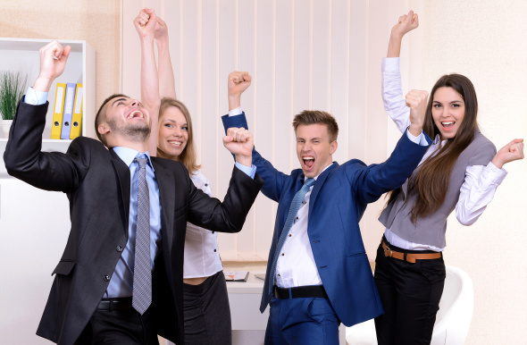 four young happy office employees