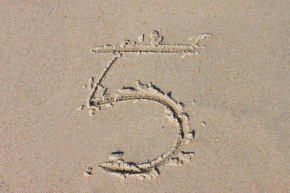 number 5 drawn in sand