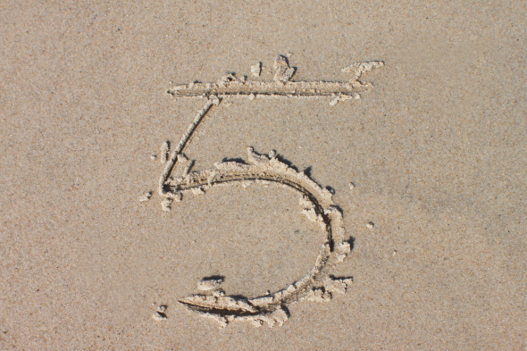 number 5 drawn in sand