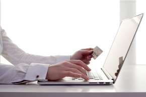 Woman entering credit card information on laptop
