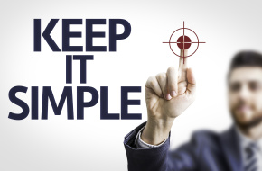 Businessman points to words "KEEP IT SIMPLE"