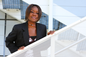 African american woman standing at stairs in an office environment. Concept: Climbing corporate ladder