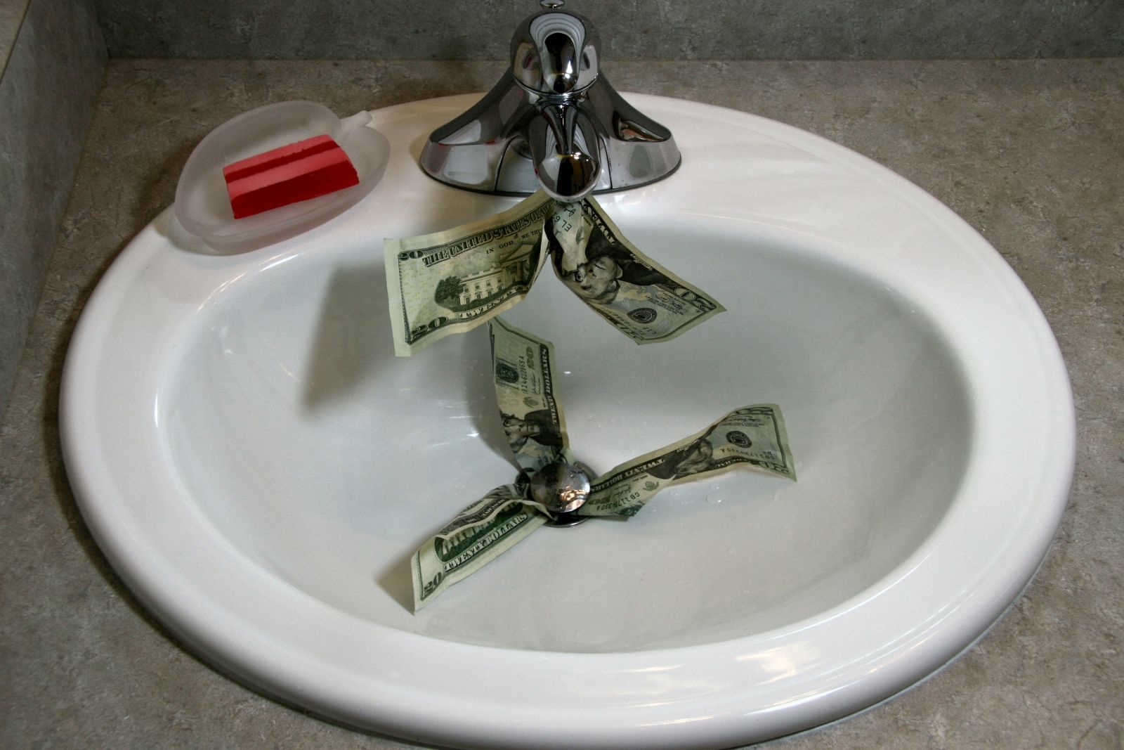 Money coming out of sink faucet and going down drain