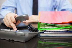 Businessman is dialing phone for advice