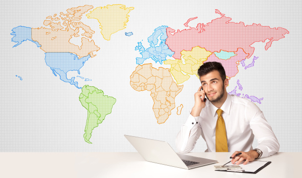 Young businessman on phone with colorful world map background