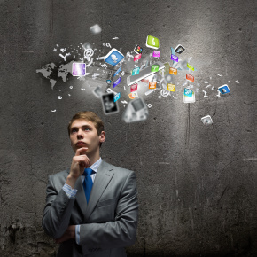Young businessman thinking, software icons in thought cloud