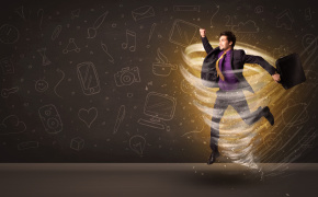 Happy young businessman jumping in tornado