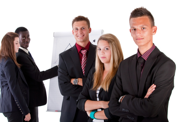 Five young business people at work in an office setting.