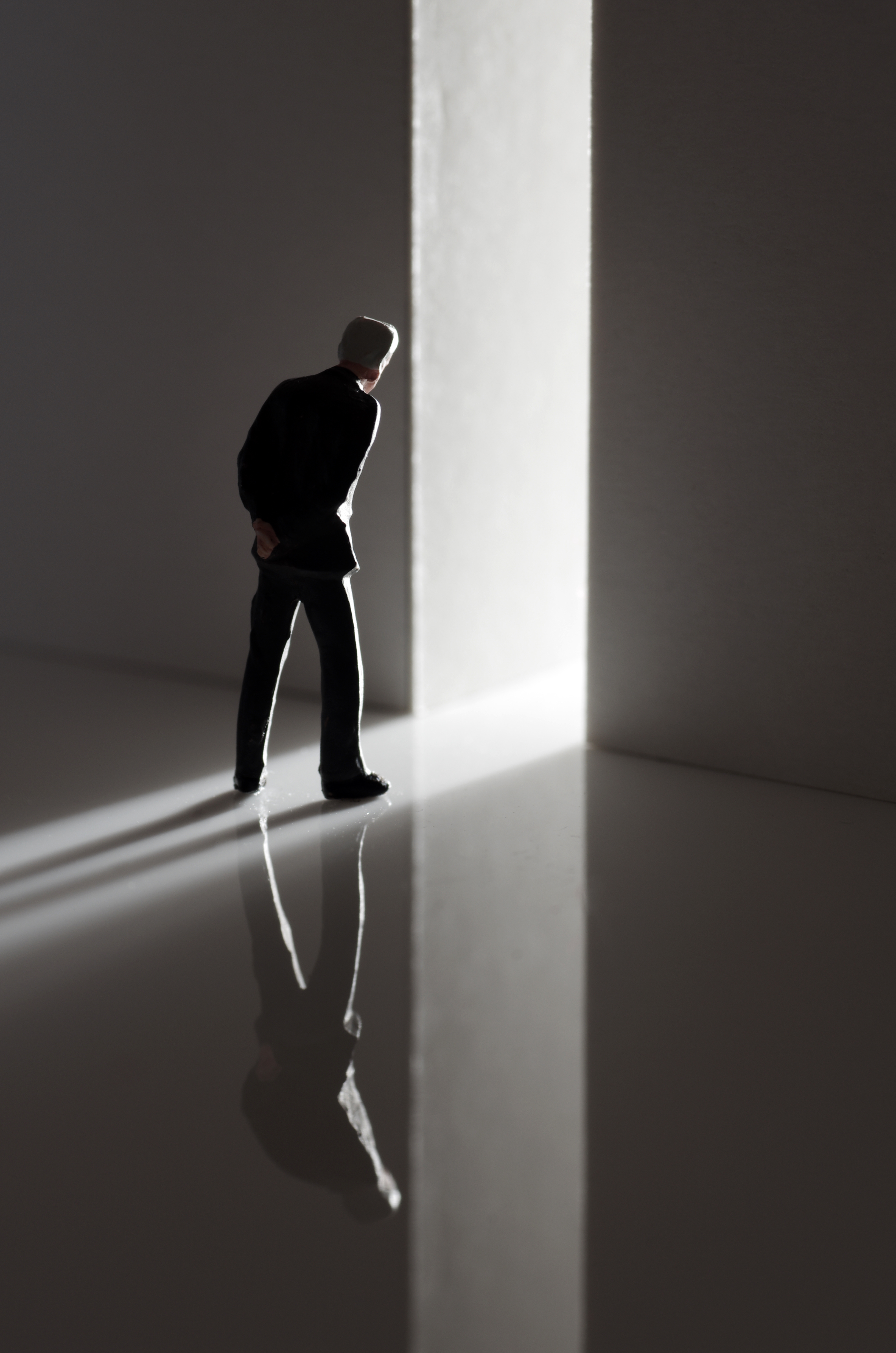 Man silhouetted facing open doorway