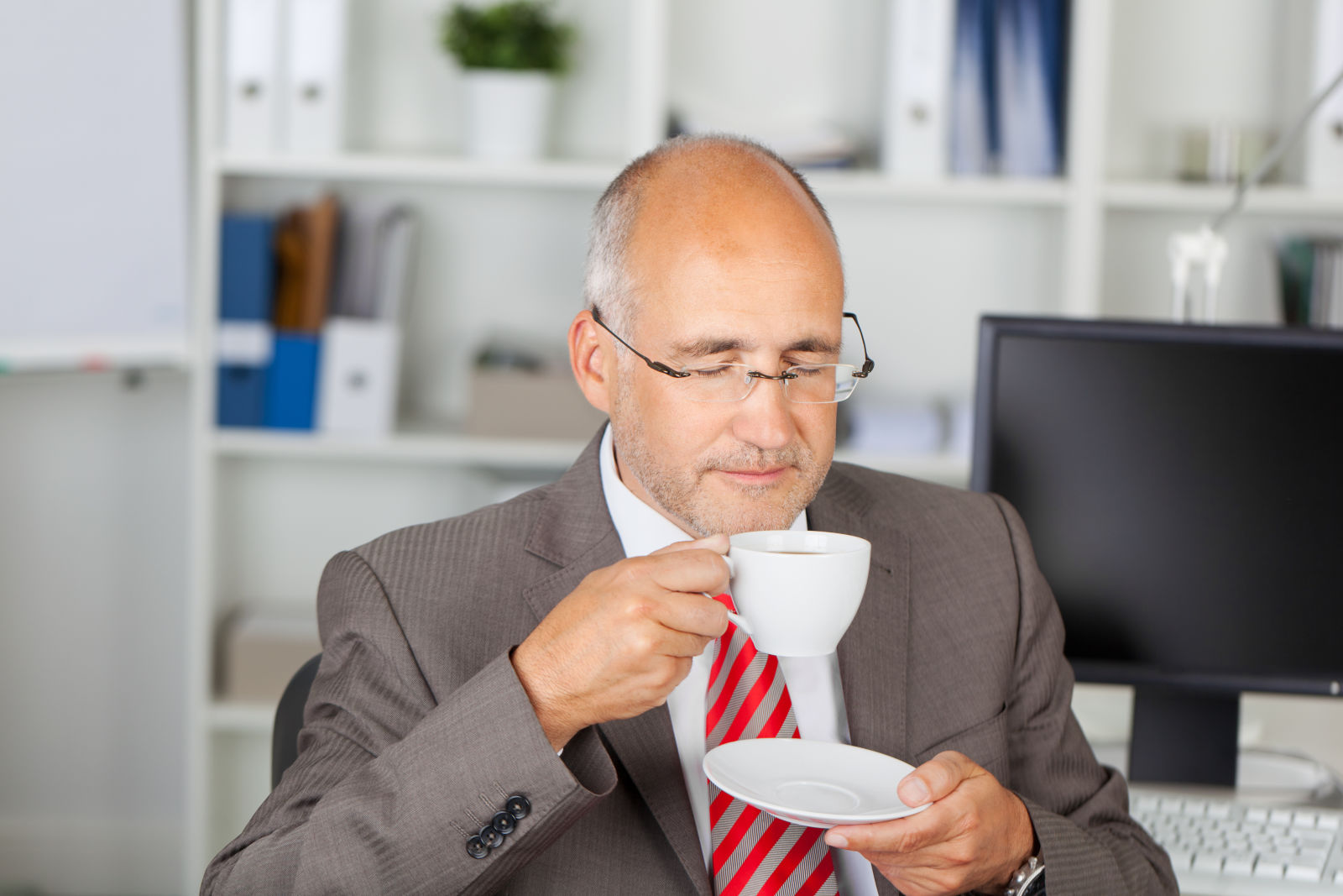 Older businessman taking a coffee break