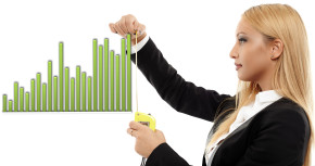 Young busineswoman evaluating a chart with a measuring tape, concept image of success