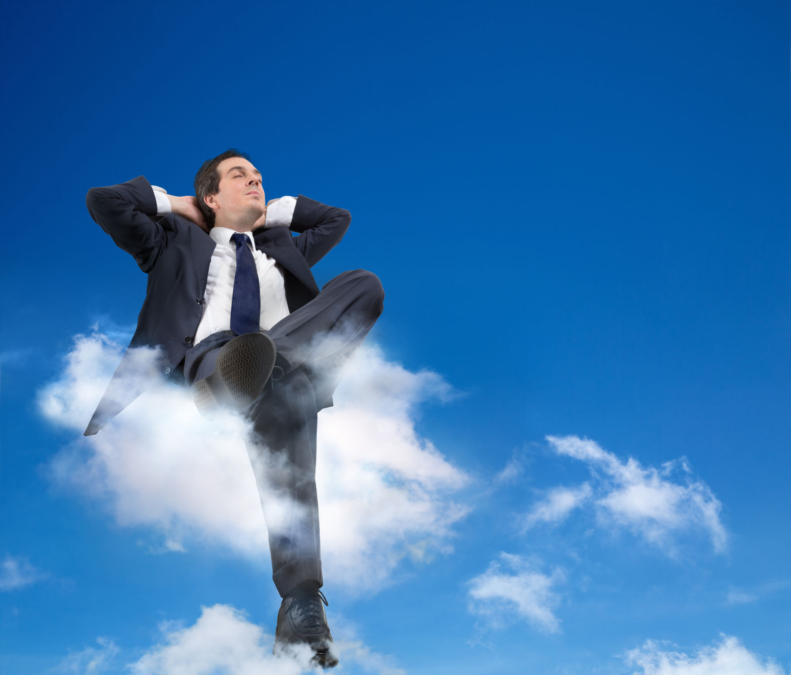 Businessman sitting on cloud