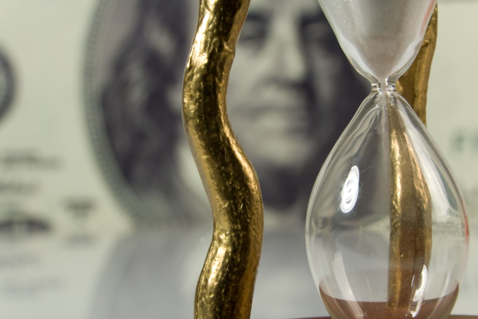 hourglass on money background