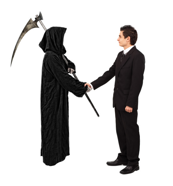 Businessman shaking hands with grim reaper