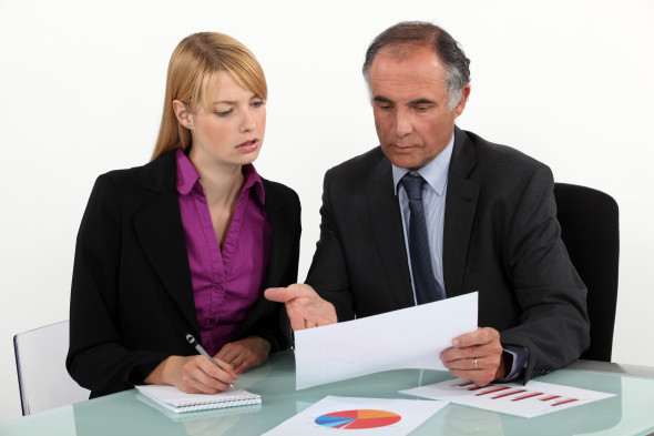 Businesspeople discussing charts