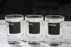 Computer keyboard with “Ctr-Alt-Delete” commands pictured on 3 shot glasses