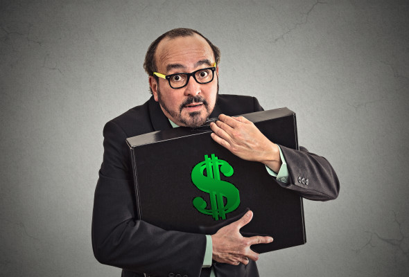 Businessman tightly holding briefcase with dollar sign on it