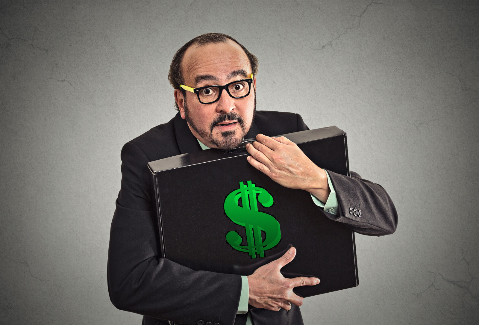 Businessman tightly holding briefcase with dollar sign on it
