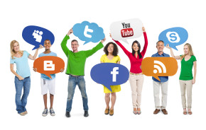 Young people holding social media logos
