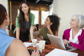 Four businesswoman having a meeting around a table