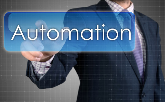 Businessman pressing virtual "automation" button