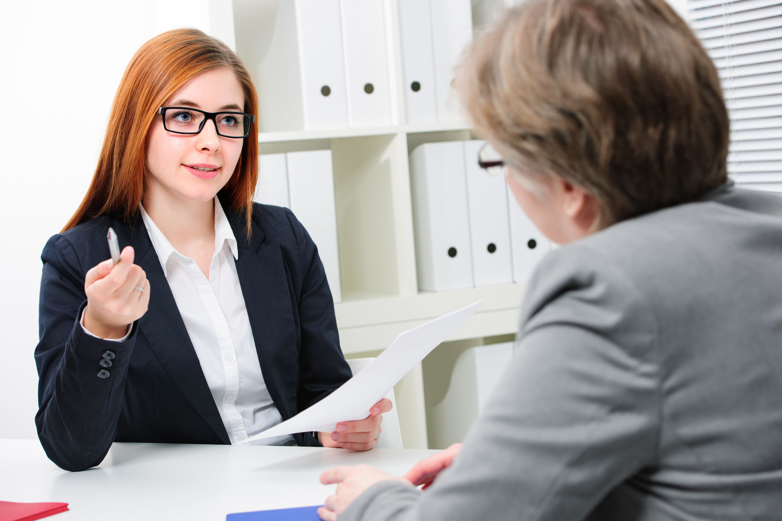 Young businesswoman speaking with client