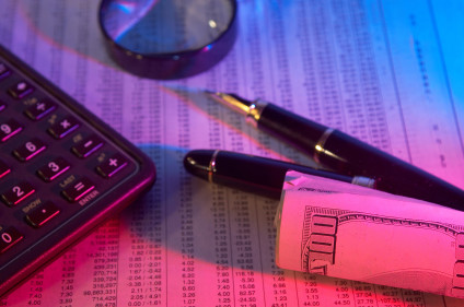 Money roll, calculator and magnifying glass