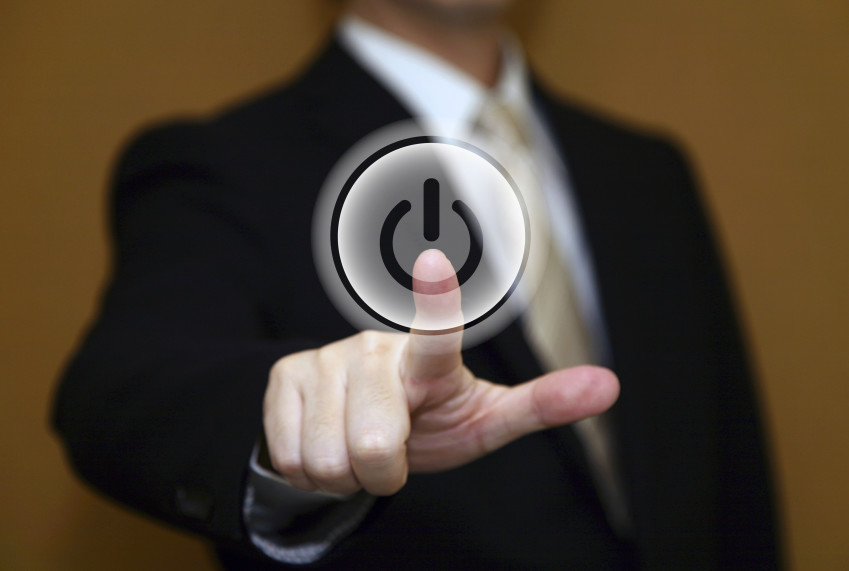 Man in suit pushing a restart button