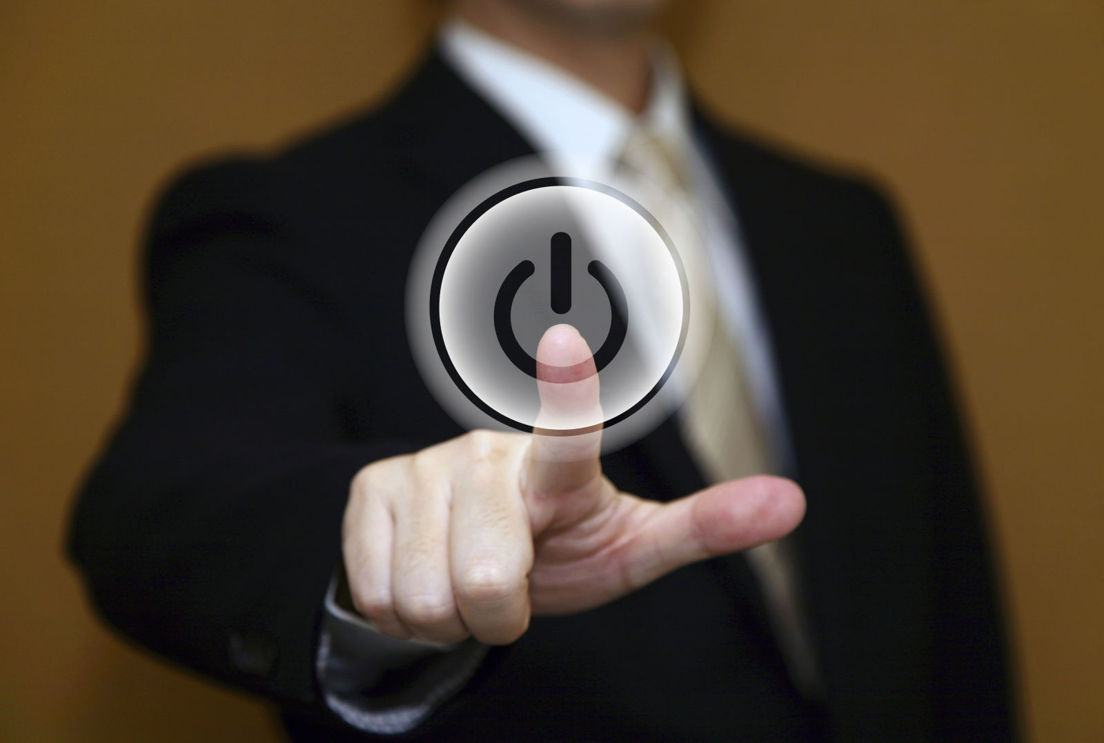 Man in suit pushing a restart button