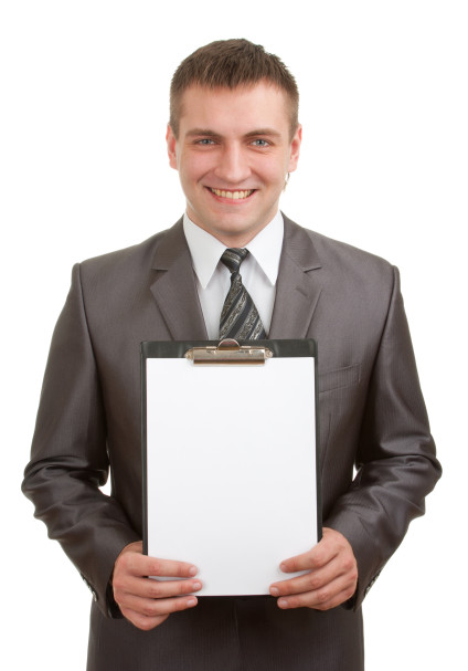 Smiling businessman holding clipboard