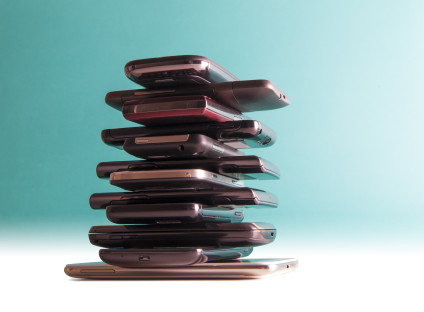 Stack of cell phones on table