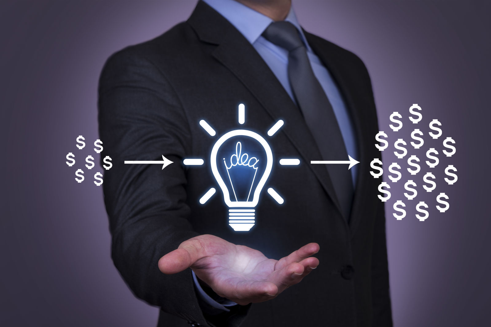 Businessman holding idea light bulb; dollars passing through grow larger