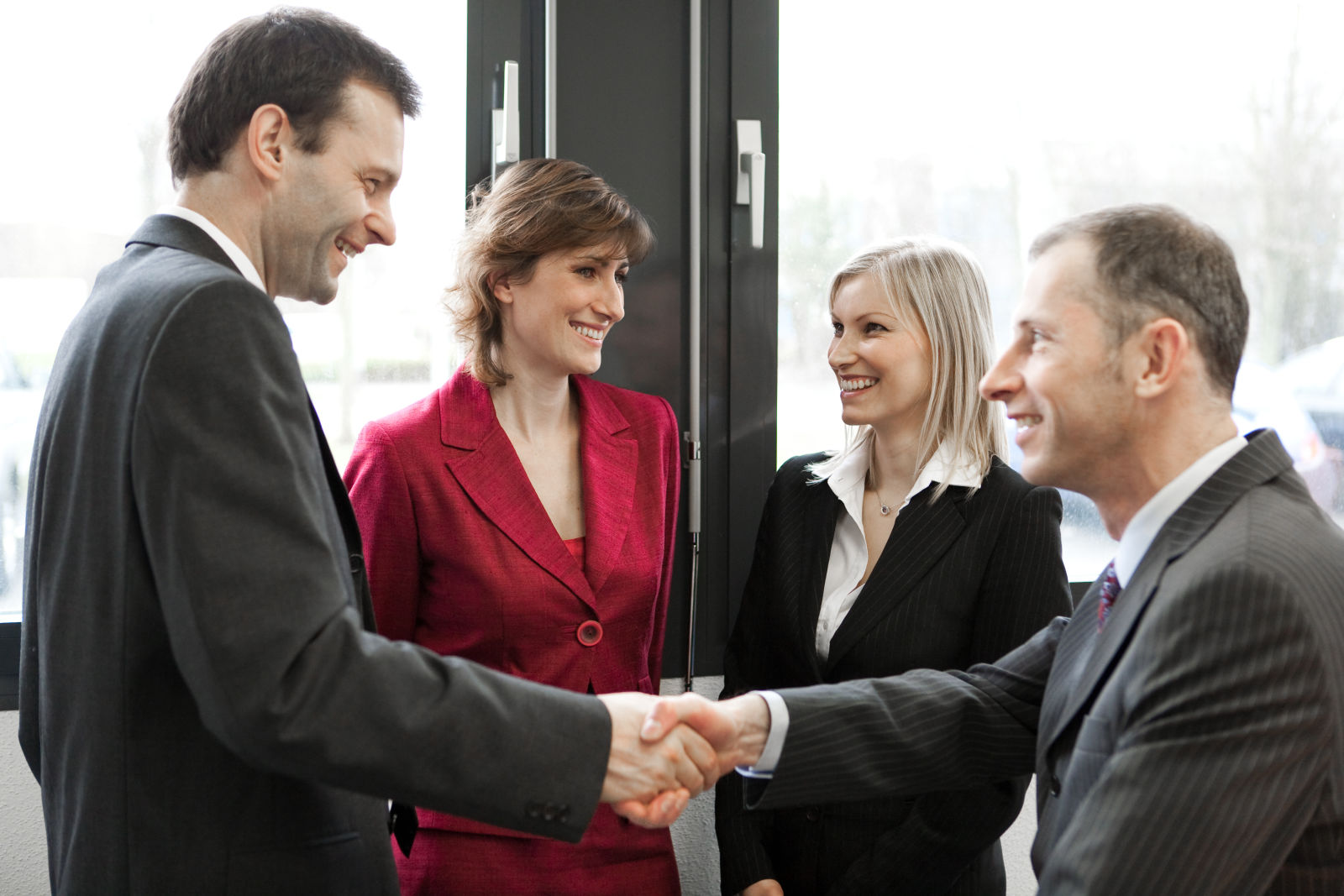 Four businesspeople greeting each other