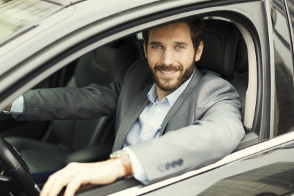 Portrait of man in his car looking at camera