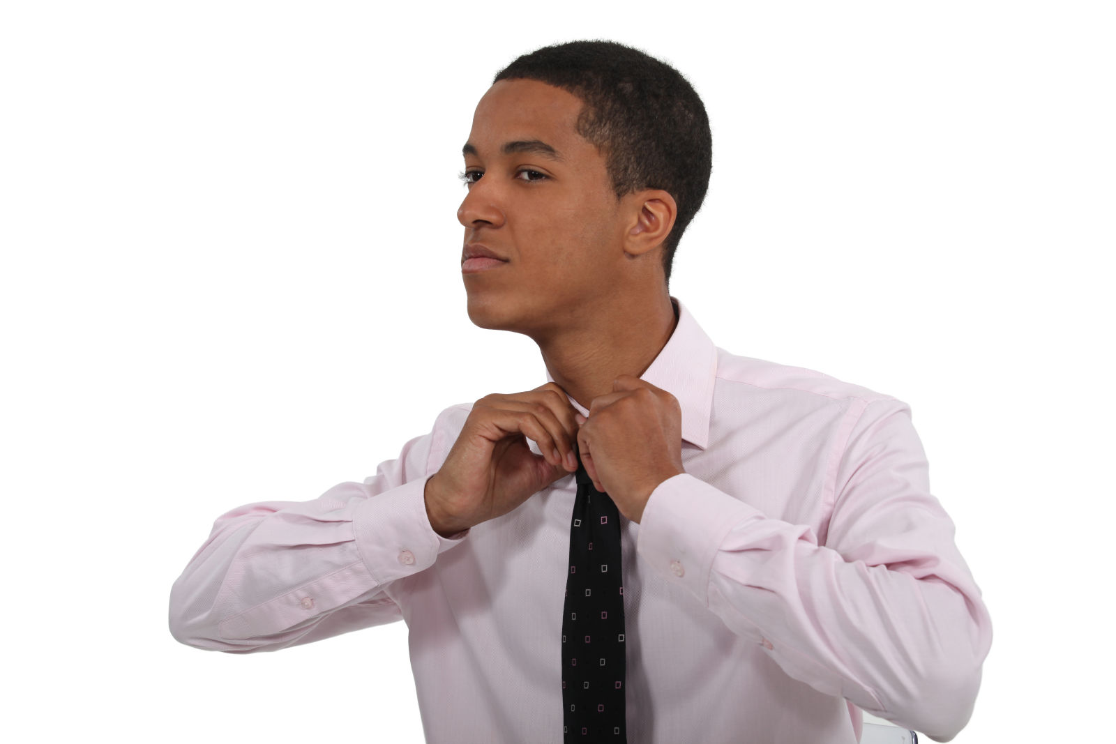 Young businessman knotting his necktie