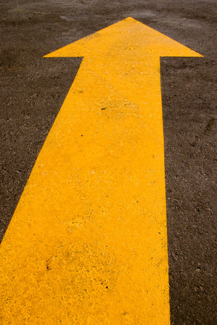Yellow arrow painted on a road