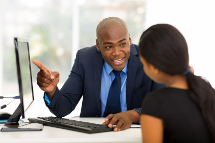 Businessman excited to show someone what is on computer screen