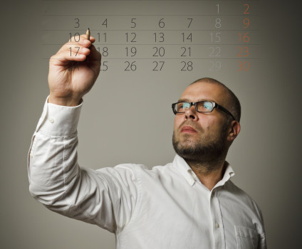 Man writing on a calendar