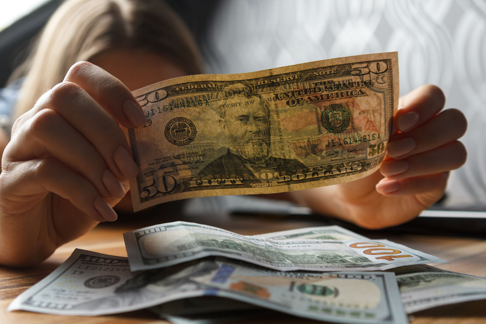 Closeup of money being counted by woman