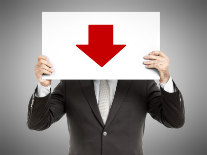 Businessman holding a printed red "down" arrow
