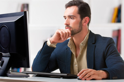 Man viewing desktop computer screen