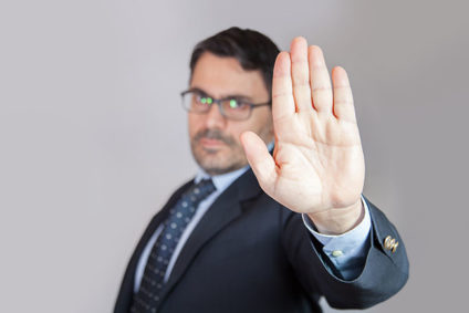Businessman holding hand up