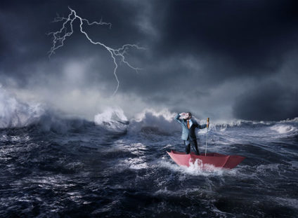 Businessman in an umbrella sails in storm in the night
