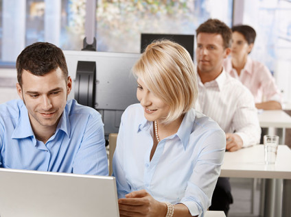 Woman training man at computer