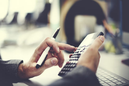Hands using a calculator