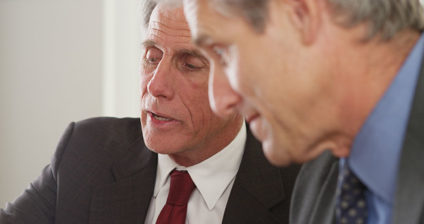 Two older businessmen talking